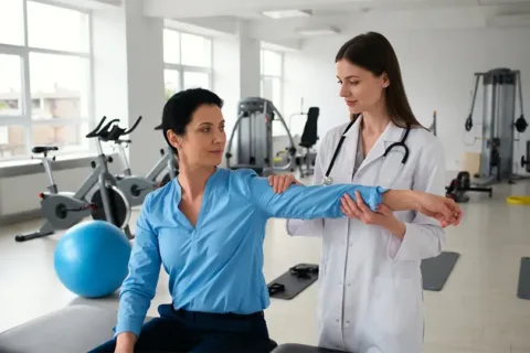 Licensed physiotherapist conducting a shoulder assessment in a top-rated clinic.