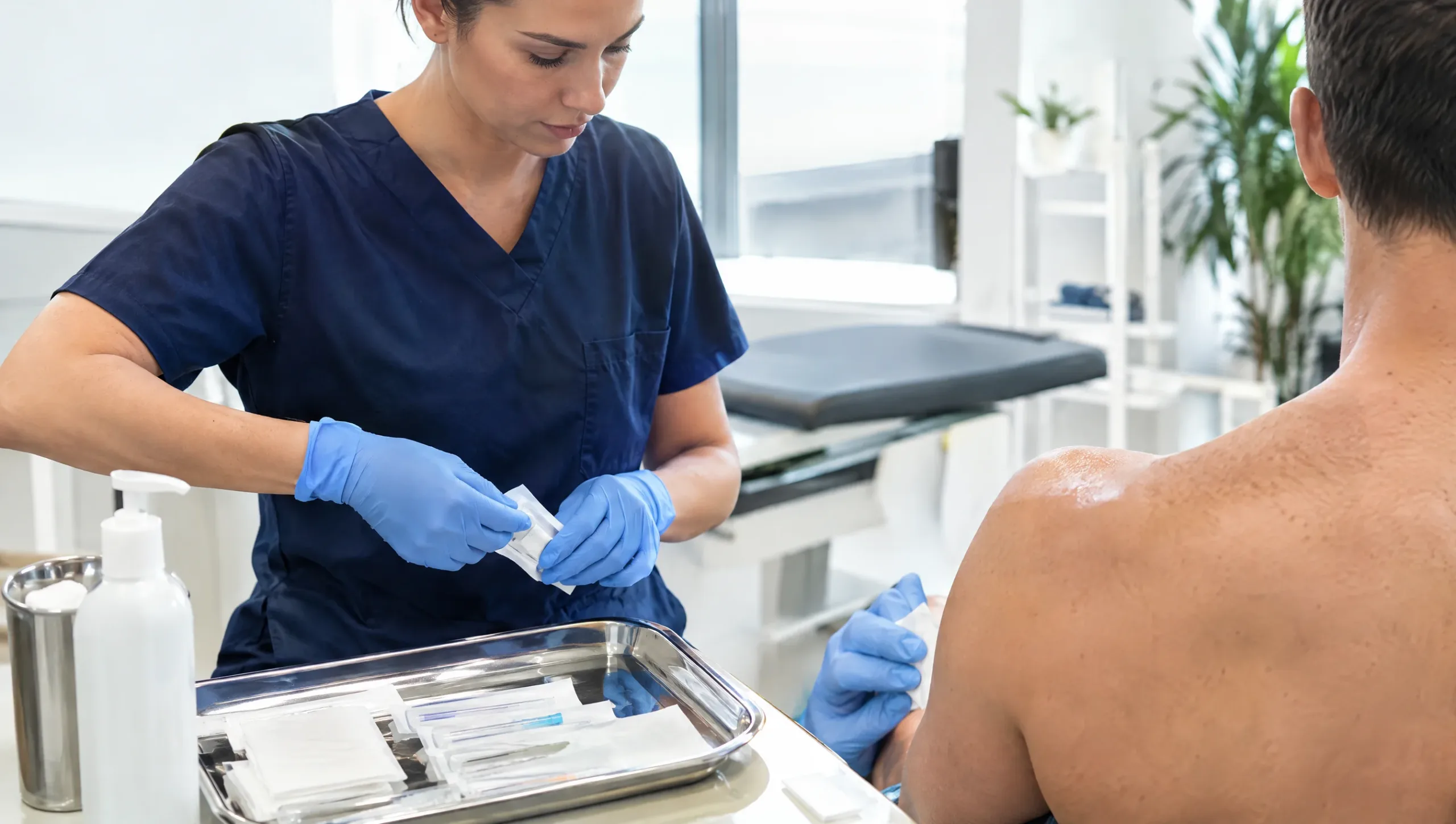 Physiotherapist preparing sterile needles before a dry needling physiotherapy session