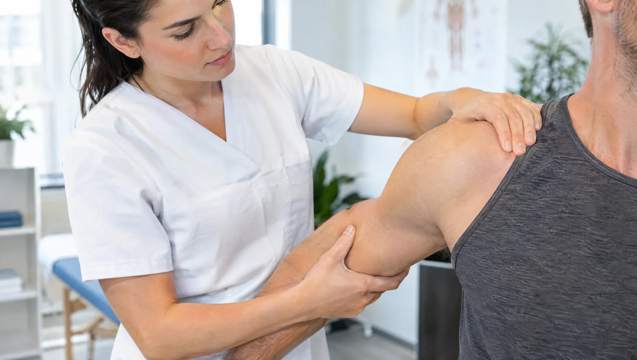 Physiotherapist examining a patient's shoulder for a rotator cuff tear