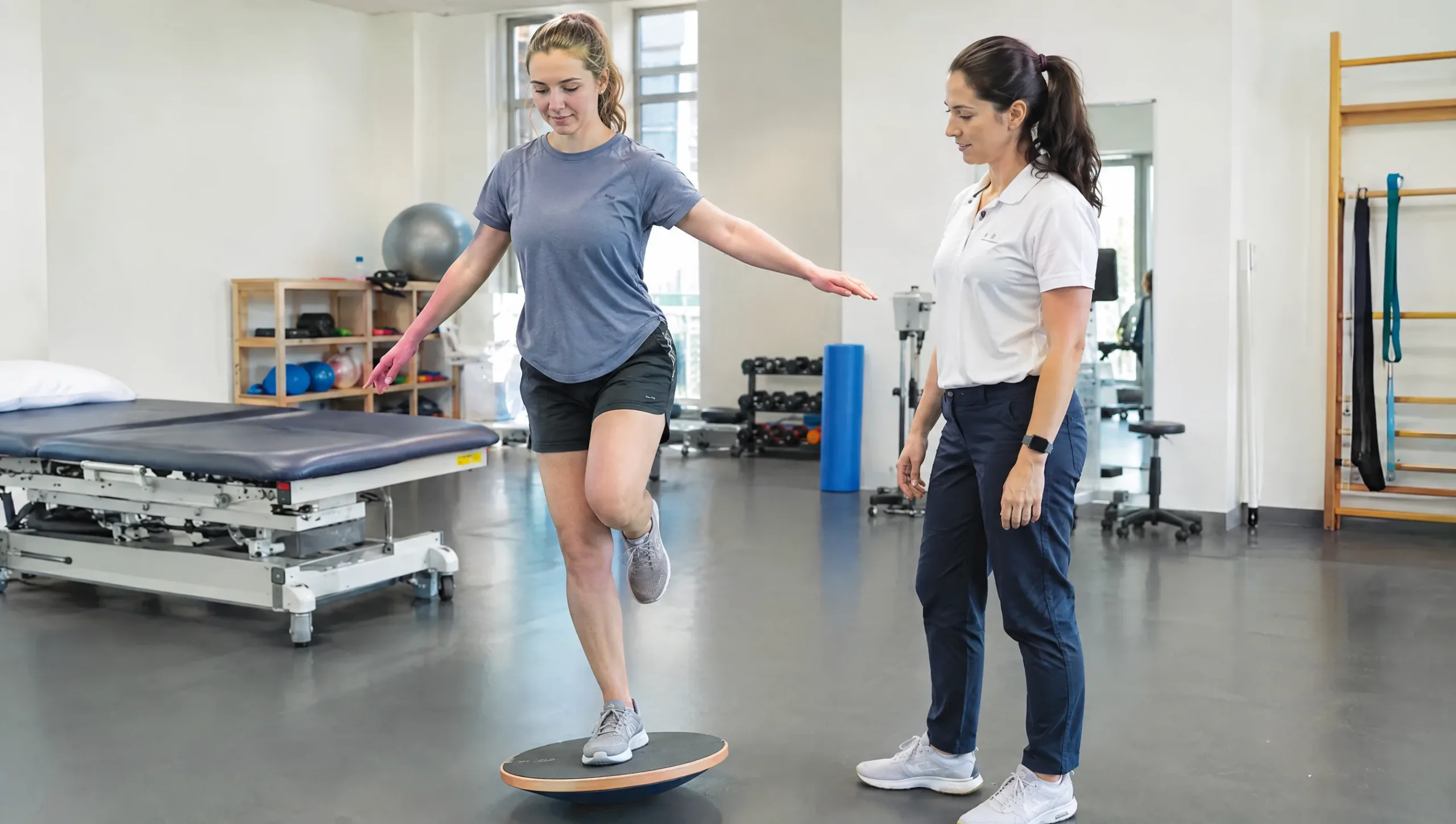 Patient performing single-leg balance exercise on wobble board during ACL rehab