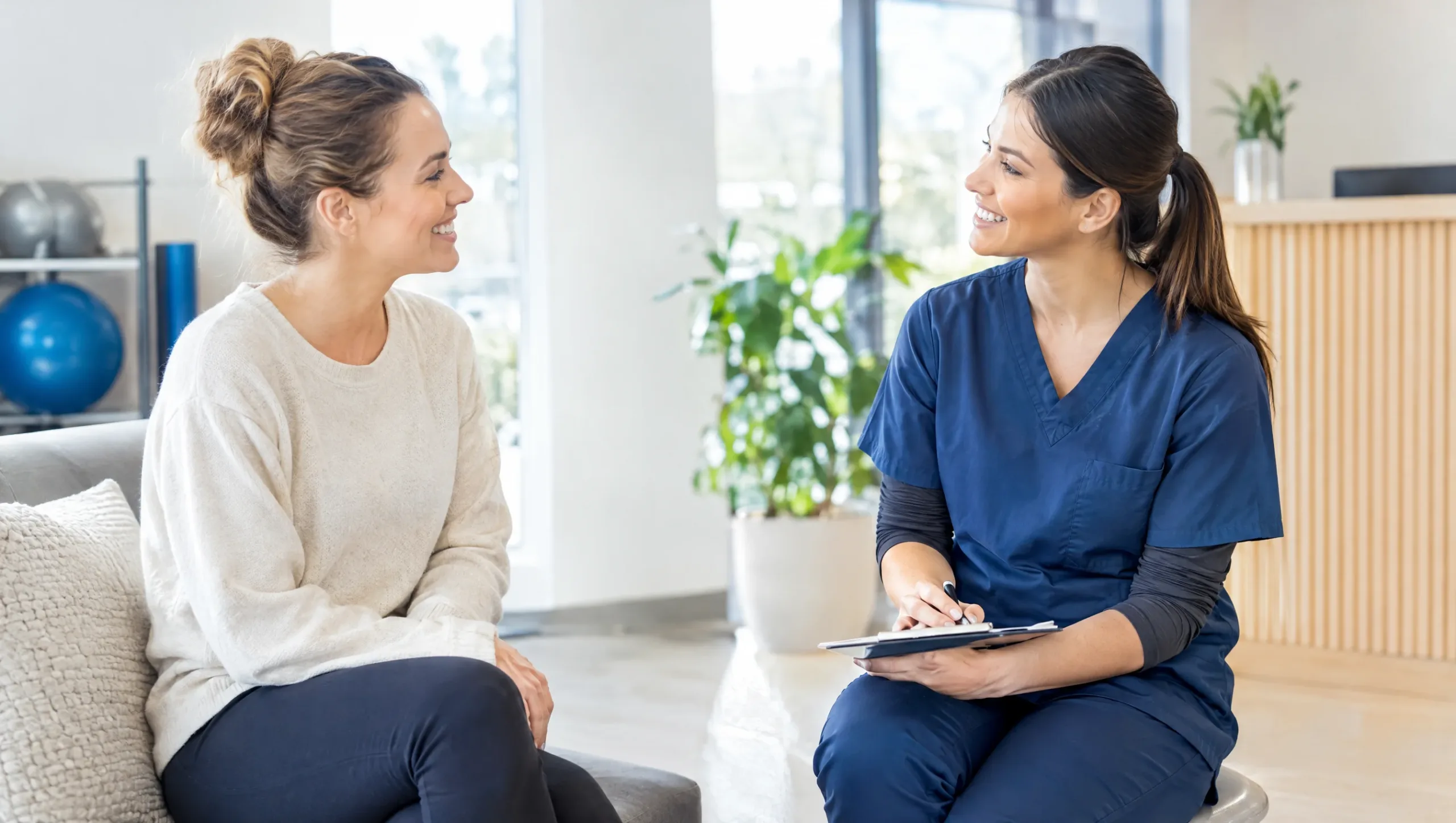 Patient and physiotherapist discussing pain scale results in clinic